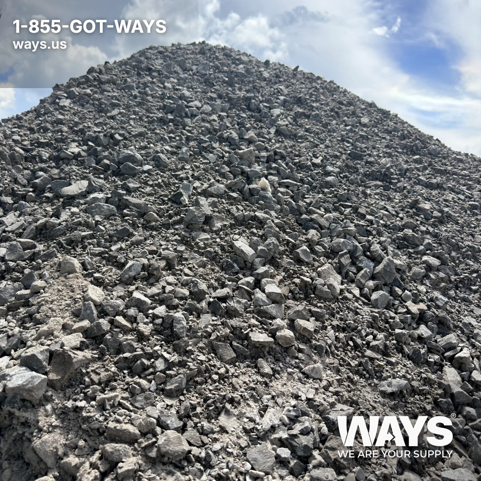 Bulk delivery truck dumping #610 limestone onto a residential driveway site